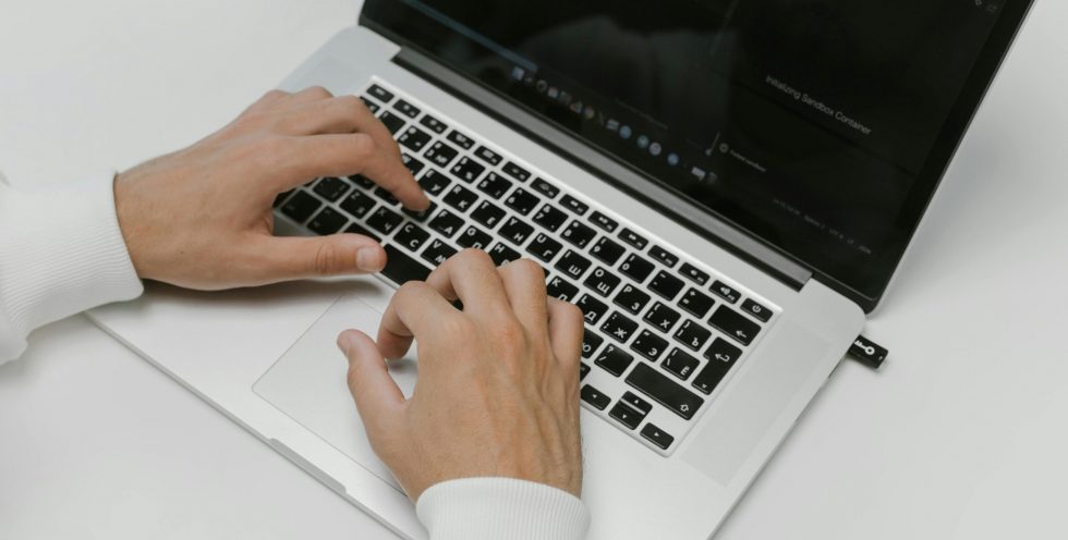 Free Hands on a Laptop Keyboard Stock Photo