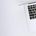 Free Aerial view of a sleek laptop keyboard on a clean, white surface, ideal for tech backgrounds. Stock Photo