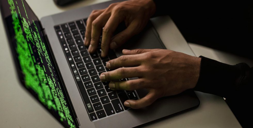 crop-cyber-spy-hacking-system-while-typing-on-laptop