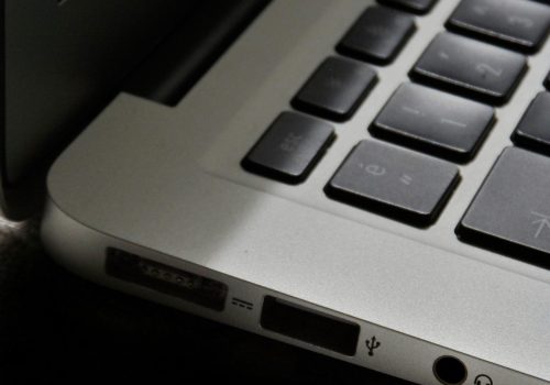 Free Detailed view of a silver laptop showing keyboard and multiple ports. Stock Photo